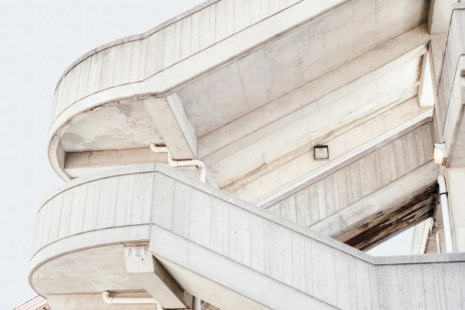 Curved concrete staircases forming a precise pattern in soft daylight.
